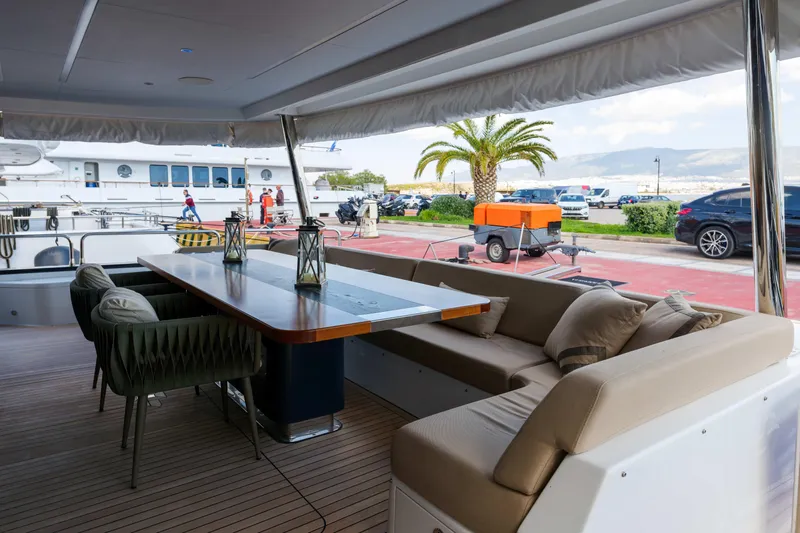 Heliophilia Yacht Photos Pics Luxurious 2024 Sirena 88 yacht deck with elegant seating and dining area.