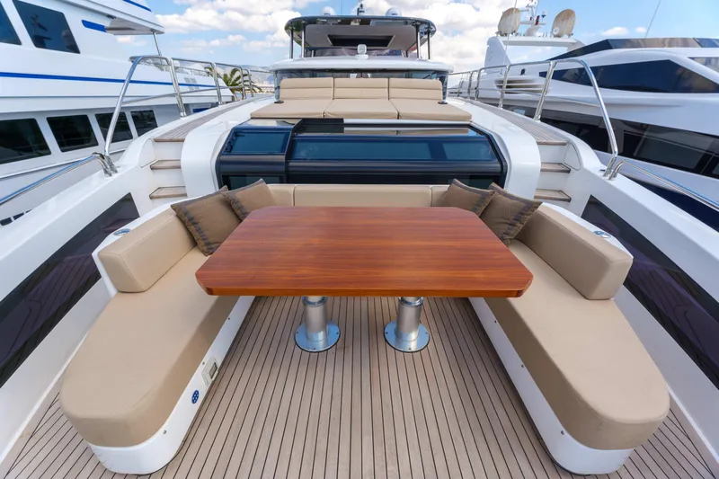 Heliophilia Yacht Photos Pics Luxurious 2024 Sirena 88 yacht deck with elegant seating and wooden table.