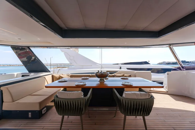 Heliophilia Yacht Photos Pics Luxurious 2024 Sirena 88 yacht interior with elegant dining area and panoramic sea views.