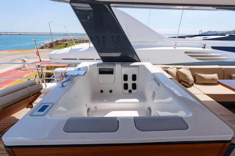 Heliophilia Yacht Photos Pics Luxurious jacuzzi on the deck of a 2024 Sirena 88 yacht, overlooking the ocean.