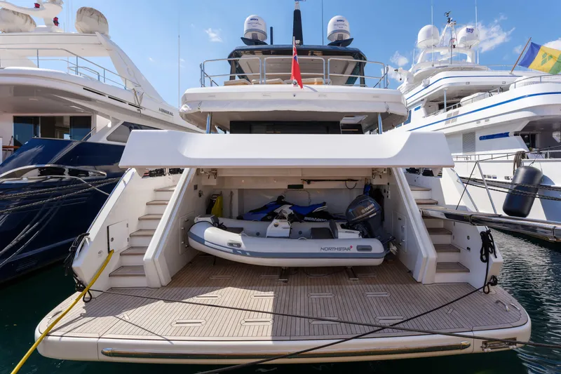 Heliophilia Yacht Photos Pics 2024 Sirena 88 yacht with open garage and tender boat at marina.