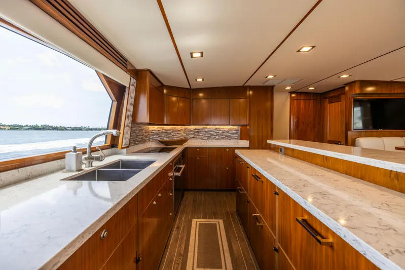 2020 Viking 80 Yacht Photos Pics Luxurious kitchen interior of 2020 Viking 80 Convertible yacht with modern wood cabinetry.