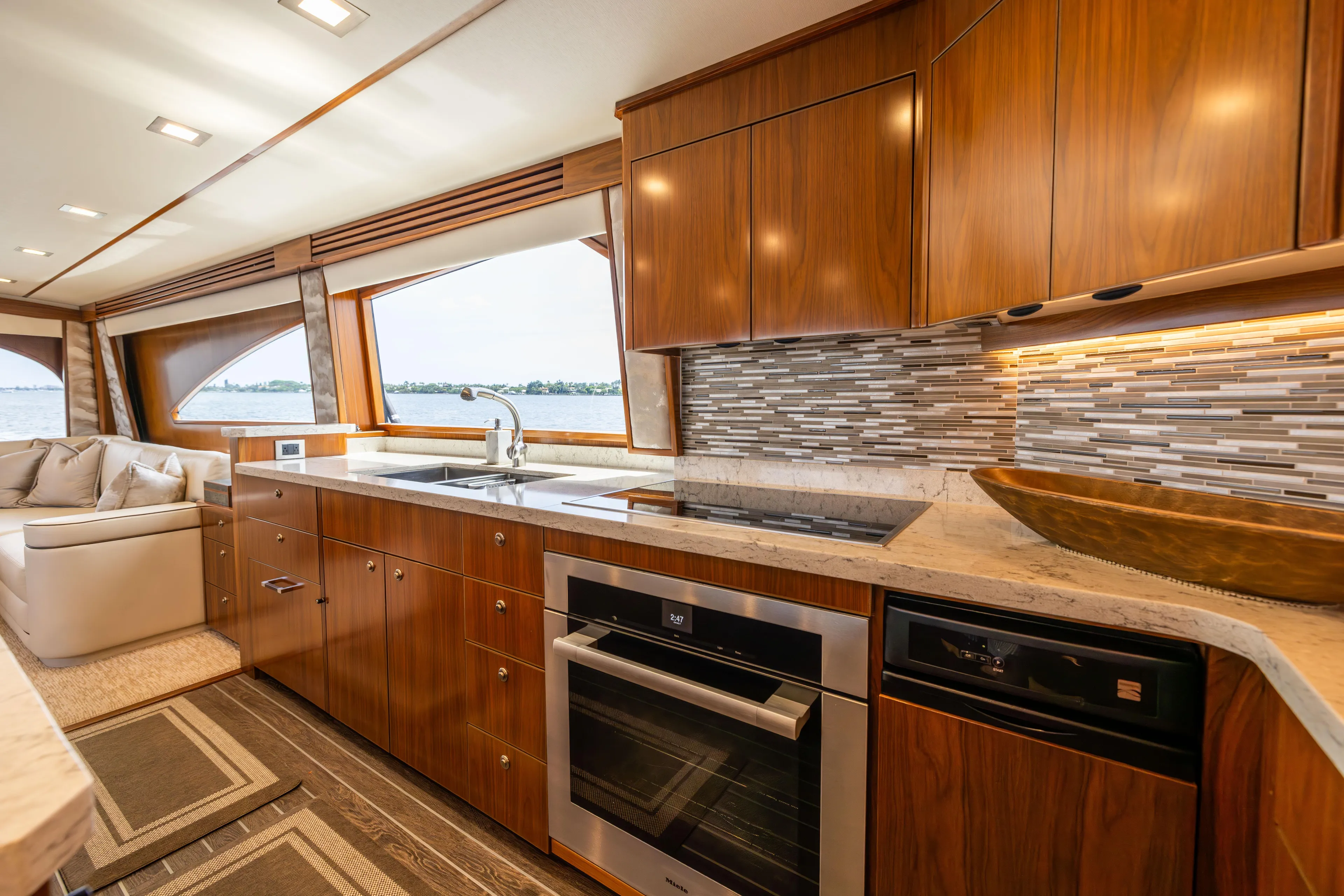 2020 Viking 80 Yacht Photos Pics Luxurious kitchen interior of 2020 Viking 80 Convertible yacht with modern appliances and wood cabinetry.