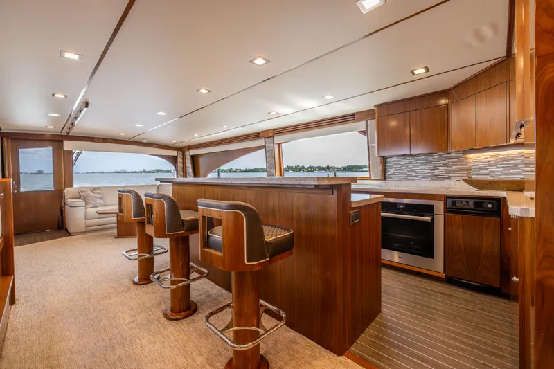 2020 Viking 80 Yacht Photos Pics Luxurious interior of 2020 Viking 80 Convertible yacht with modern kitchen and seating area.