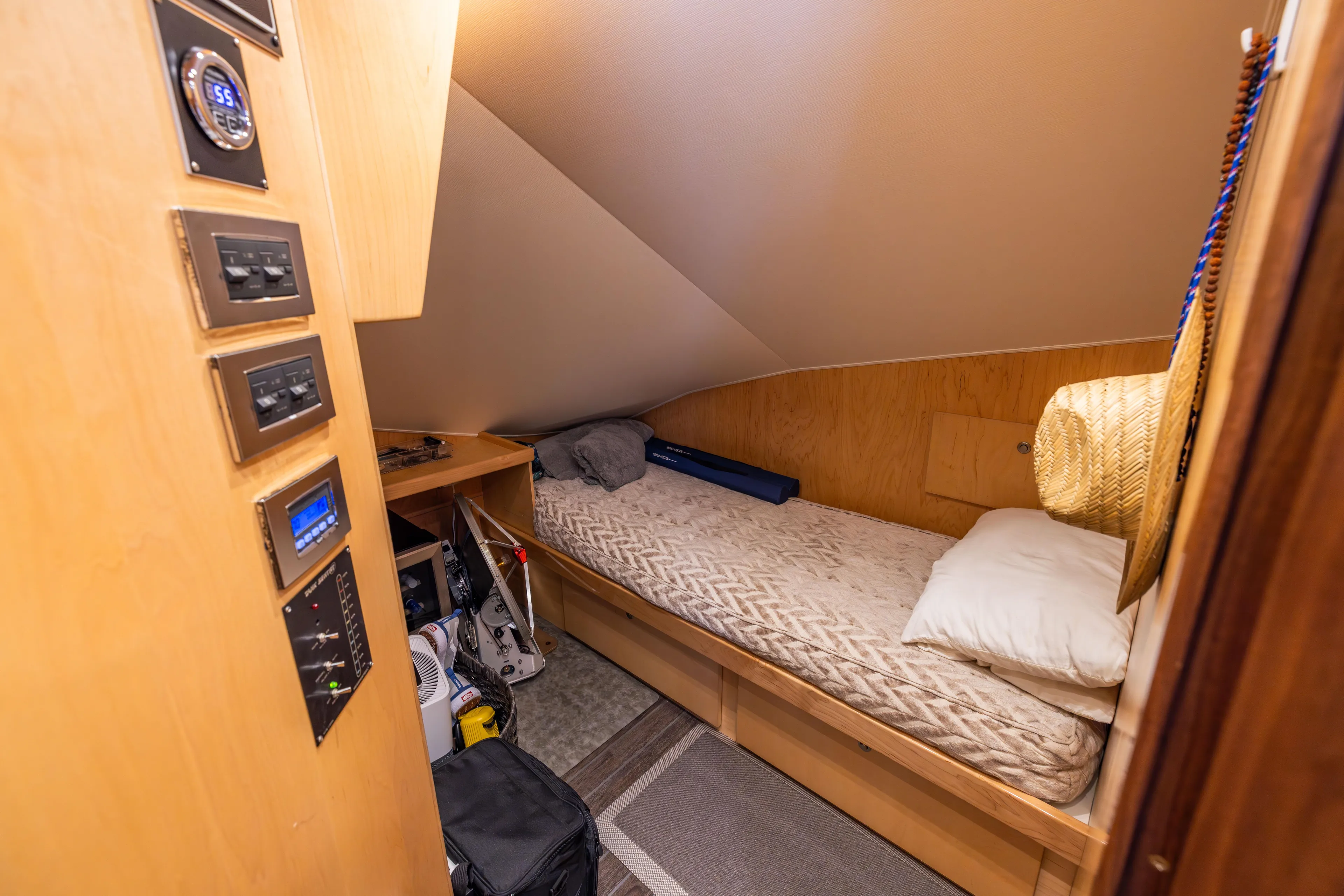 2020 Viking 80 Yacht Photos Pics Cozy cabin interior of 2020 Viking 80 Convertible yacht with single bed and control panel.