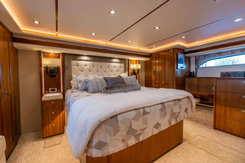 2020 Viking 80 Yacht Photos Pics Luxurious bedroom interior of 2020 Viking 80 Convertible yacht with elegant wood finishes.