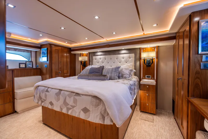 2020 Viking 80 Yacht Photos Pics Luxurious bedroom interior of 2020 Viking 80 Convertible yacht with elegant wood finishes.