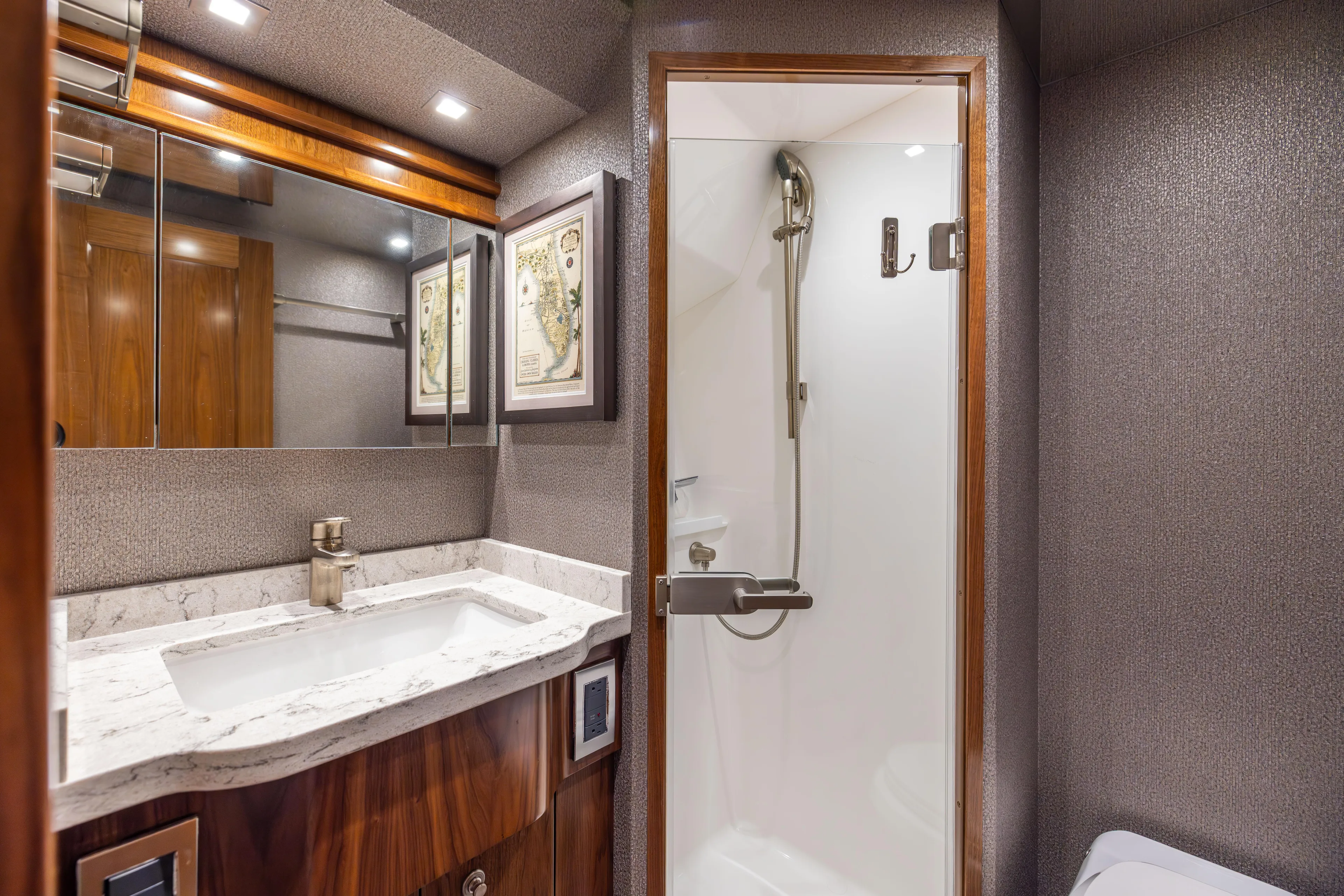 2020 Viking 80 Yacht Photos Pics Luxurious bathroom in 2020 Viking 80 Convertible yacht with marble sink and modern shower.