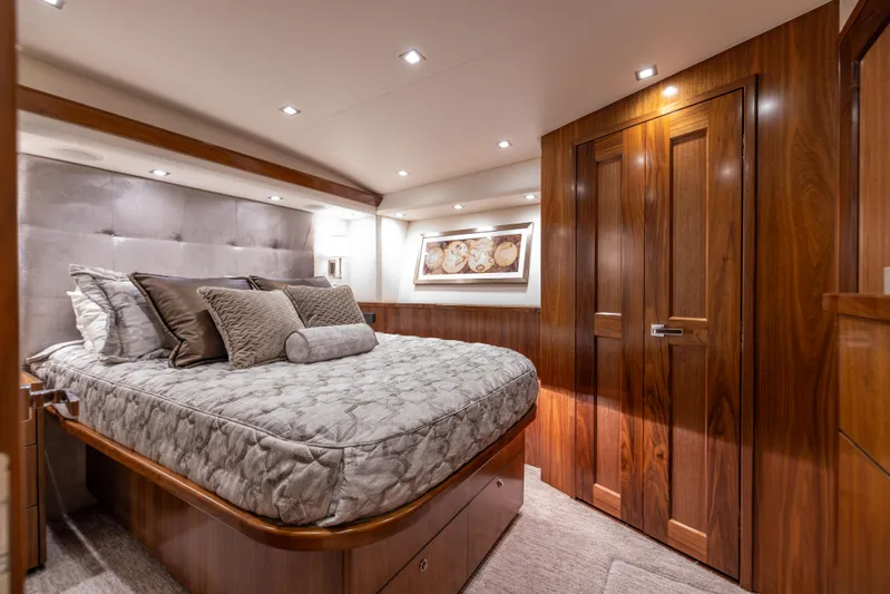 2020 Viking 80 Yacht Photos Pics Luxurious bedroom interior of 2020 Viking 80 Convertible yacht with elegant wood finishes.
