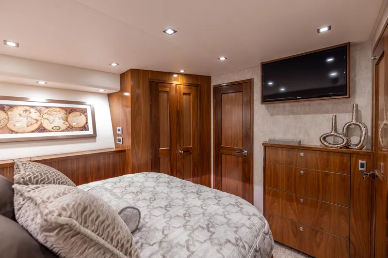 2020 Viking 80 Yacht Photos Pics Luxurious bedroom interior of 2020 Viking 80 Convertible yacht with elegant wood finishes.