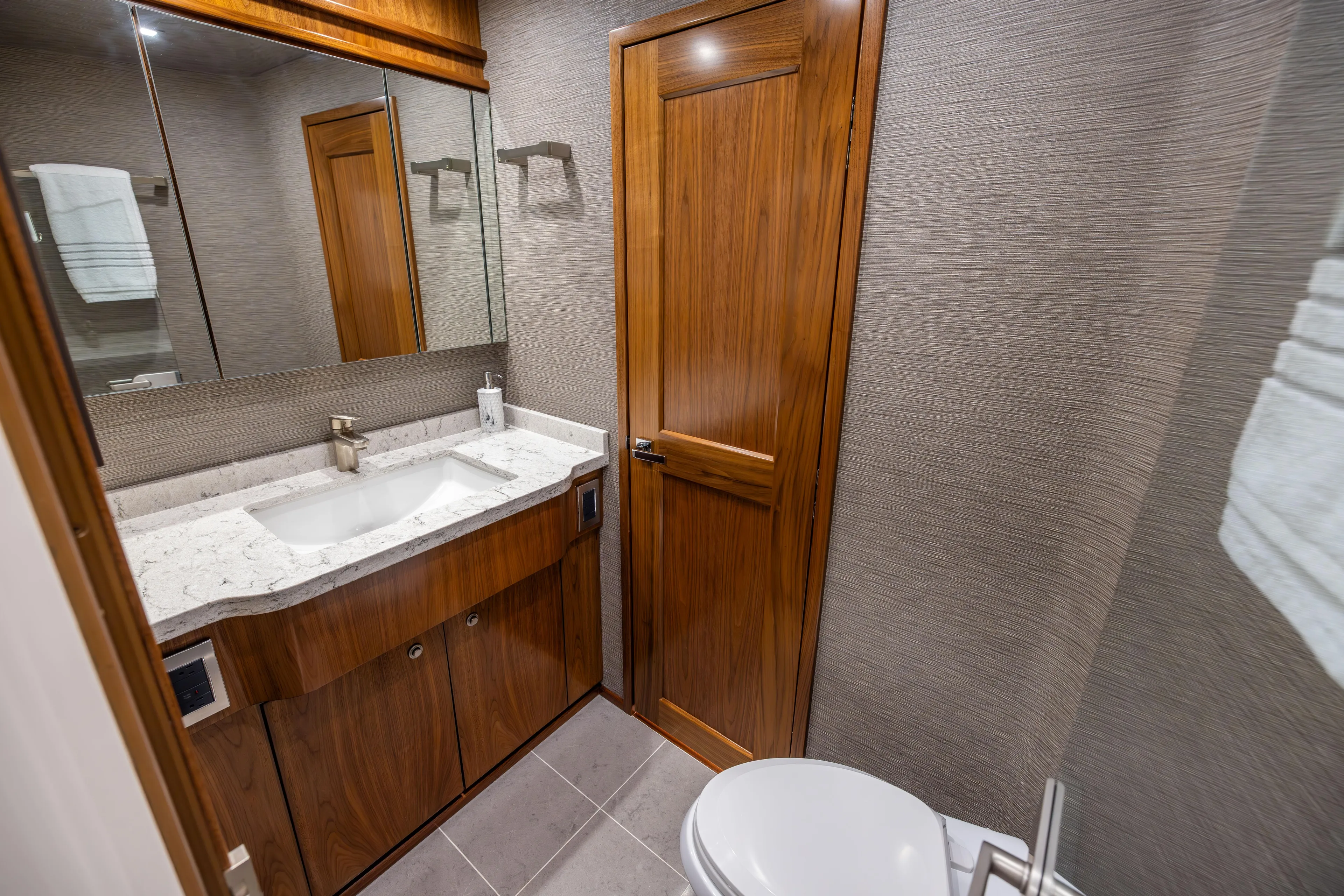 2020 Viking 80 Yacht Photos Pics Luxurious bathroom in 2020 Viking 80 Convertible yacht with wood accents and modern fixtures.