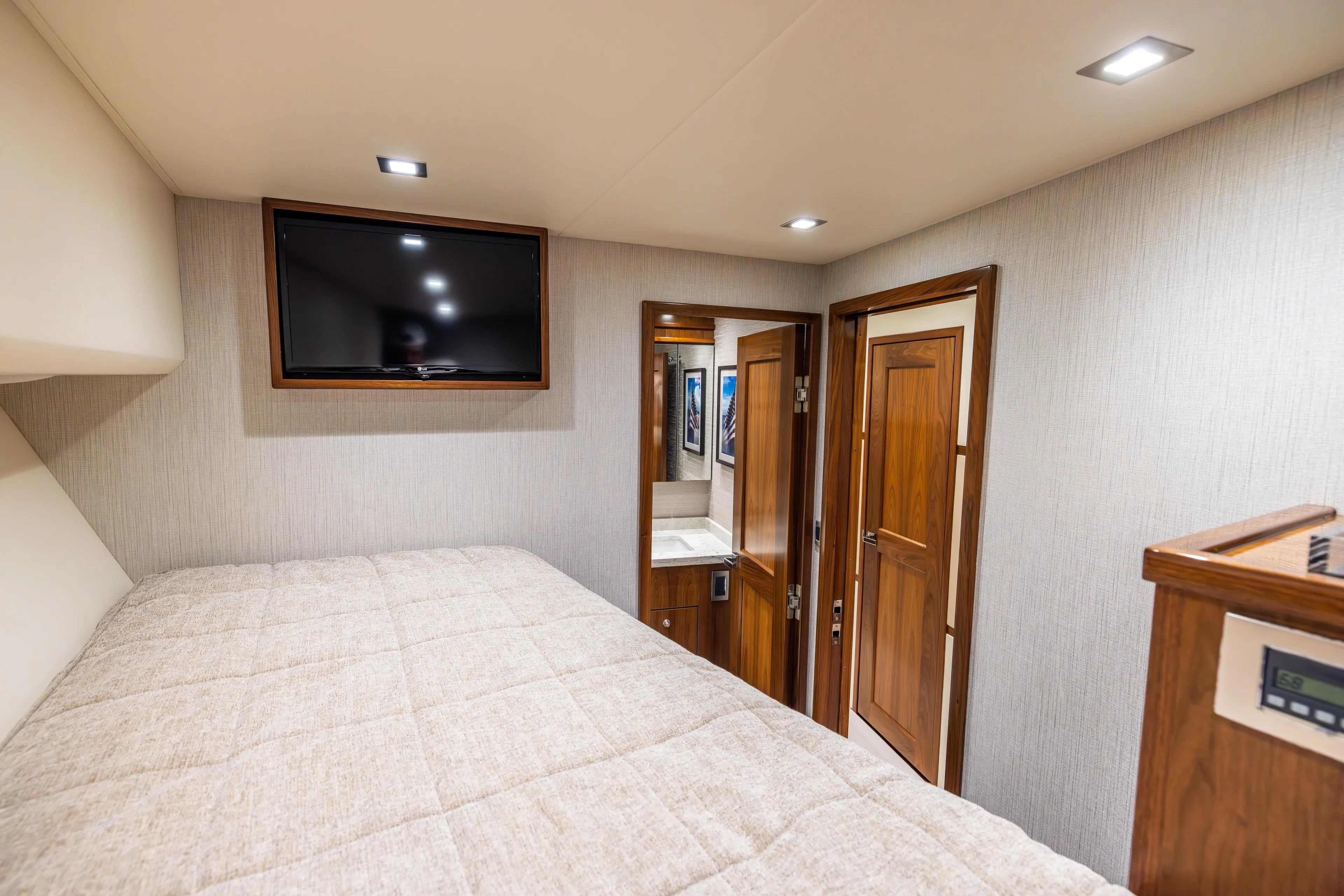 2020 Viking 80 Yacht Photos Pics Luxurious bedroom interior of 2020 Viking 80 Convertible yacht with TV and wooden accents.