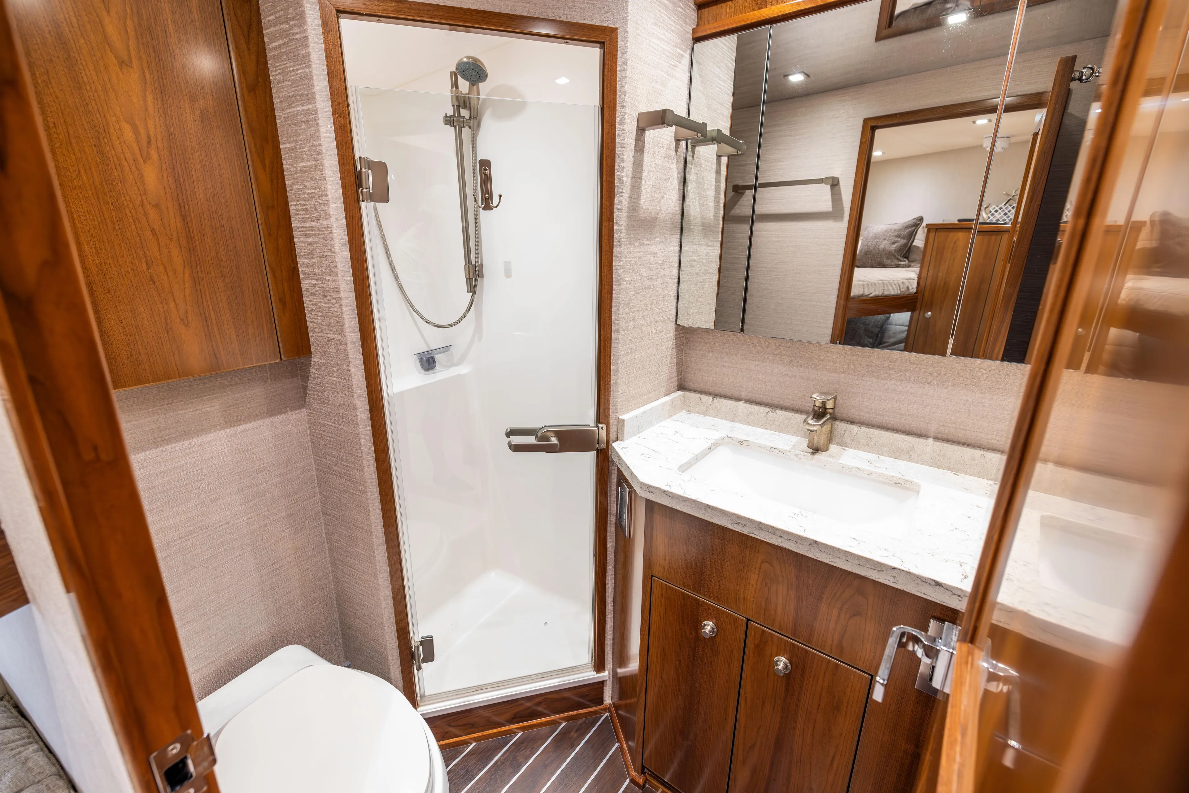2020 Viking 80 Yacht Photos Pics Luxurious bathroom in 2020 Viking 80 Convertible yacht with modern fixtures and wood accents.