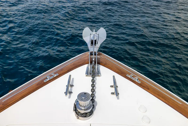 2020 Viking 80 Yacht Photos Pics Bow of 2020 Viking 80 Convertible yacht with anchor chain over blue water.