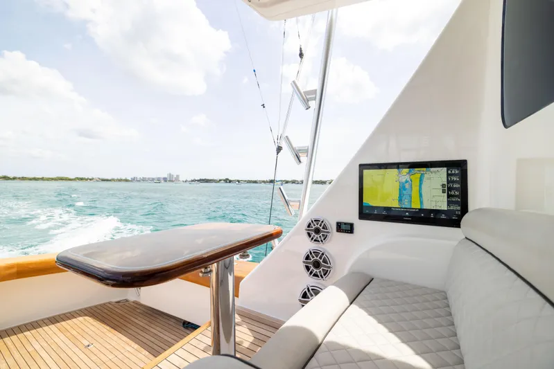 2020 Viking 80 Yacht Photos Pics 2020 Viking 80 Convertible yacht interior with navigation screen, luxurious seating, and ocean view.