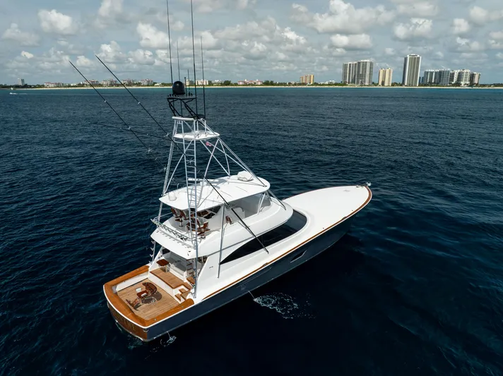 2020 Viking 80 Yacht Photos Pics 2020 Viking 80 Convertible yacht cruising on open water near a city skyline.