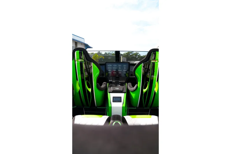  Yacht Photos Pics Interior view of 2025 Performance Powerboats P360 with green racing seats and digital dashboard.