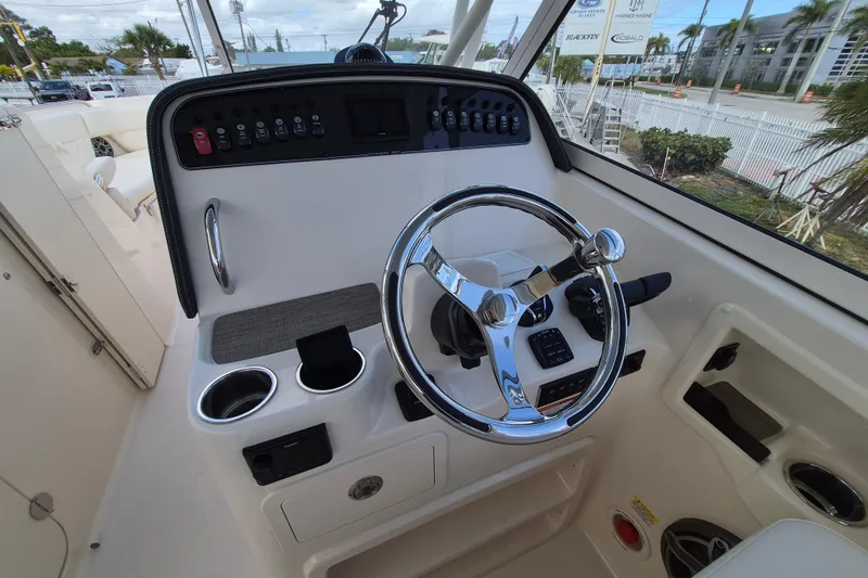 307-628 Yacht Photos Pics 2026 Grady-White Freedom 307 boat helm with chrome steering wheel and control panel.