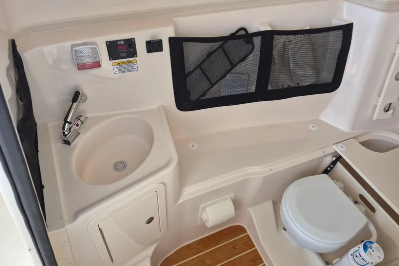 307-628 Yacht Photos Pics 2026 Grady-White Freedom 307 boat interior with sink and toilet.