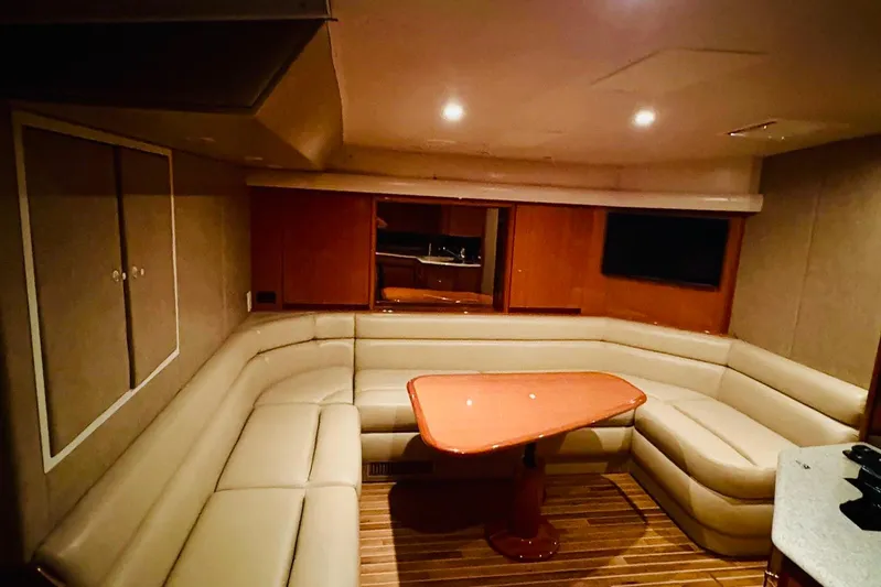  Yacht Photos Pics Luxurious interior of 2004 Viking 45 Convertible yacht with plush seating and wooden table.