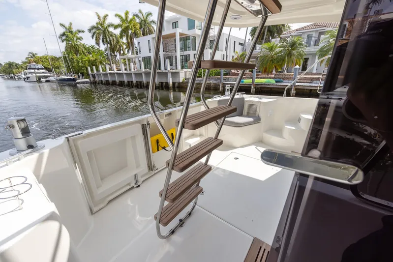 Unfiltered Yacht Photos Pics 2023 Beneteau Swift Trawler 35 deck with stairs, docked by waterfront homes.