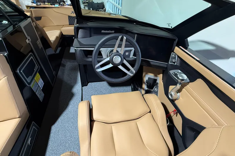  Yacht Photos Pics 2026 MasterCraft XT24 boat interior with tan leather seats and modern steering wheel.