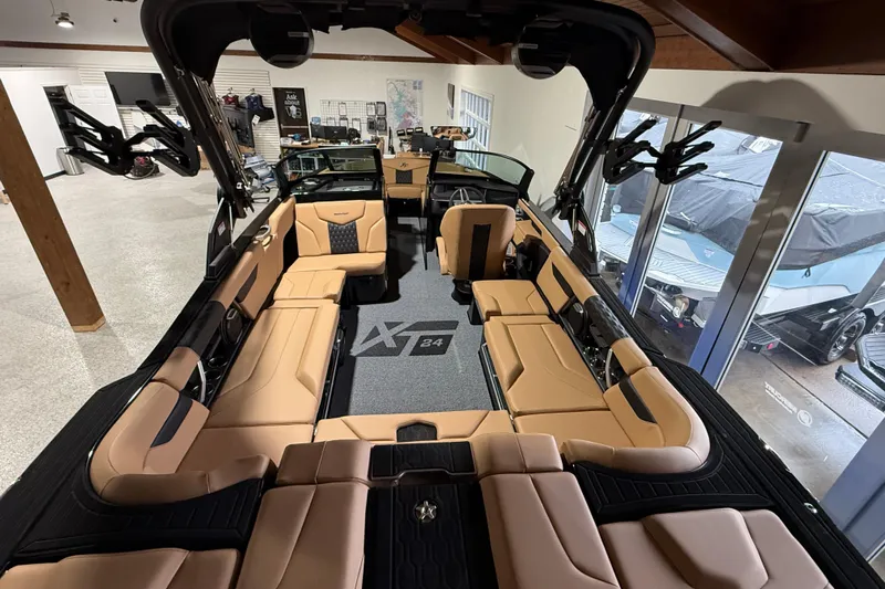  Yacht Photos Pics 2026 MasterCraft XT24 boat interior with tan seating and modern design in showroom.
