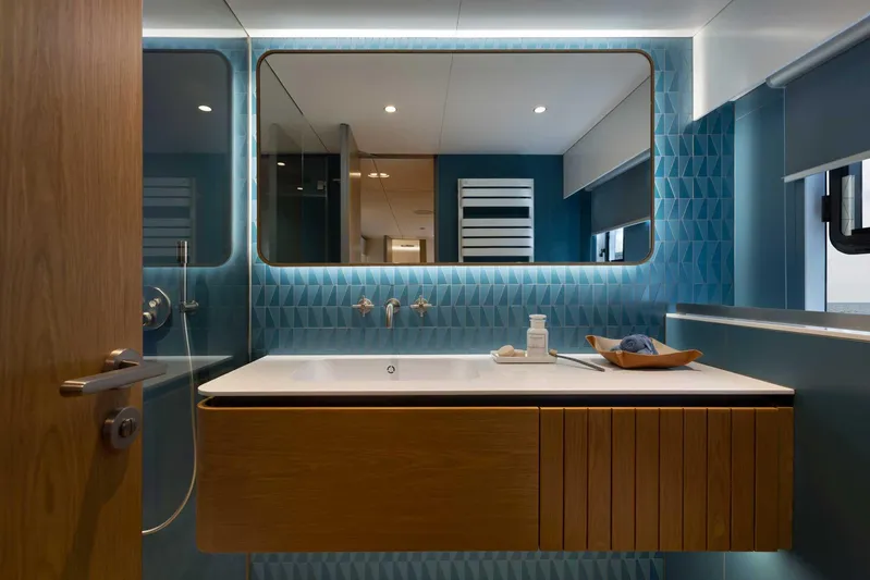  Yacht Photos Pics Luxurious bathroom interior on 2026 Sunreef 80 Sunreef Power yacht, featuring modern design and blue accents.