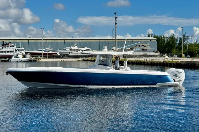 Yacht Photos Pics 2020 Intrepid 407 Nomad FE boat on water, blue hull, clear sky background.