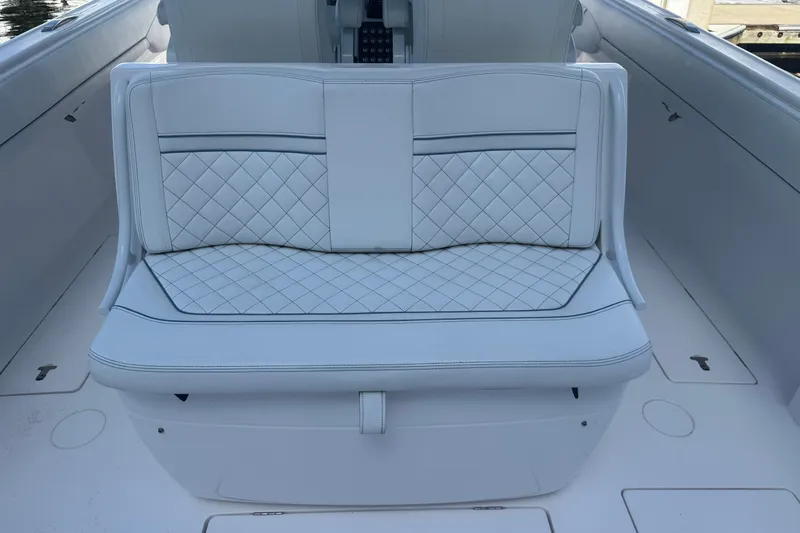 Yacht Photos Pics Luxury seating on 2020 Intrepid 407 Nomad FE boat, featuring quilted white upholstery.
