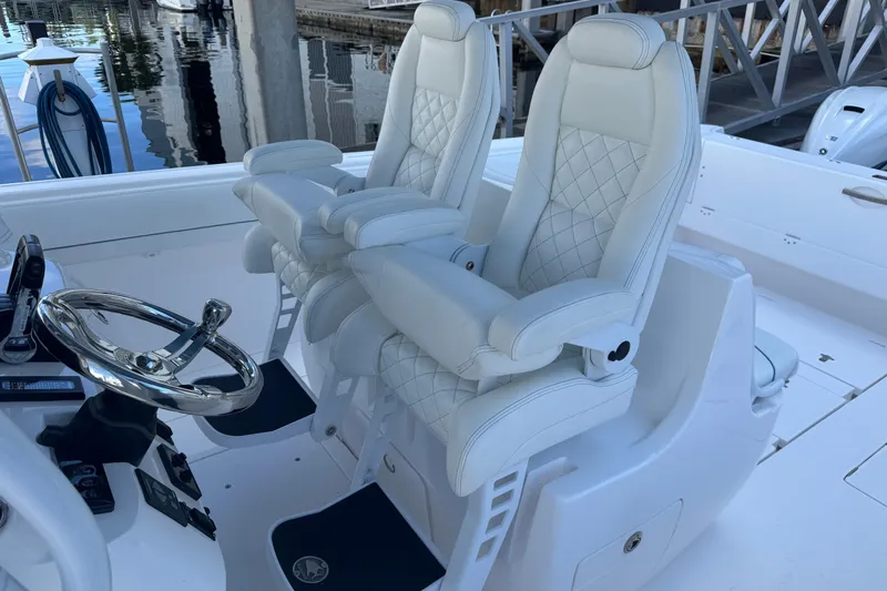  Yacht Photos Pics Luxury helm seats on 2020 Intrepid 407 Nomad FE boat, featuring elegant white upholstery.