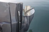 Outboard motor of 2017 Quicksilver 675 Sundeck on calm water.