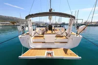 Hanse 460 yacht, 2022 model, docked in a marina with clear blue water.