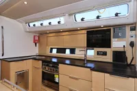 Modern kitchen interior of 2022 Hanse 460 yacht with sleek cabinetry and appliances.
