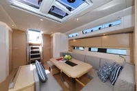 Interior of 2022 Hanse 460 yacht with modern seating and skylights.