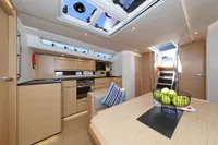 Modern interior of 2022 Hanse 460 yacht with kitchen and dining area.