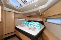 Luxurious cabin interior of 2022 Hanse 460 yacht with modern design and skylights.