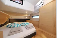 Cozy cabin interior of 2022 Hanse 460 yacht with bed and modern design.