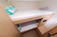 Bunk beds in 2022 Hanse 460 yacht cabin with modern design and cozy bedding.