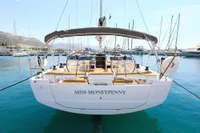 2022 Hanse 460 yacht "Miss Moneypenny" docked in a marina, clear blue water.
