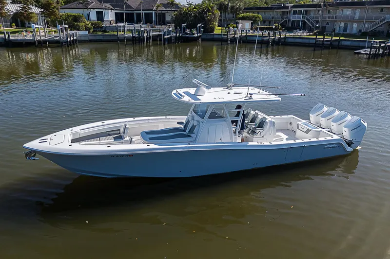  Yacht Photos Pics 2024 Invincible 39 Open Fisherman boat on calm water, featuring sleek design and powerful engines.