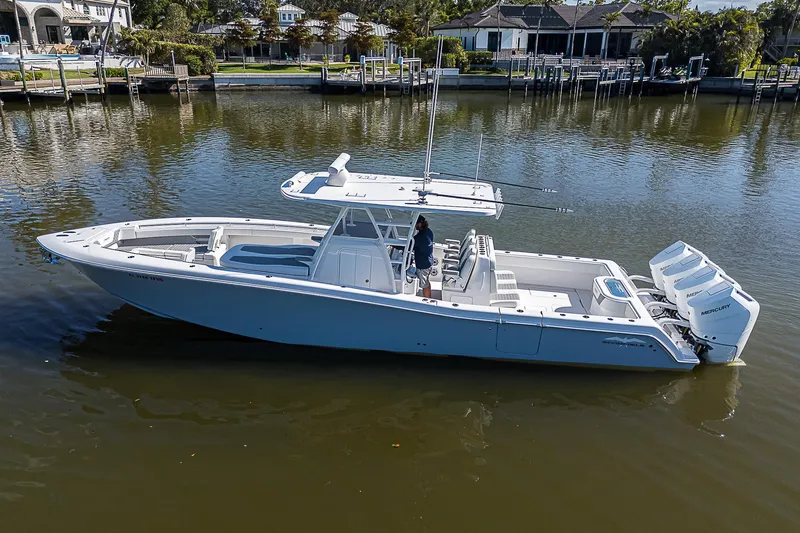 Yacht Photos Pics 2024 Invincible 39 Open Fisherman boat on calm water, side view.