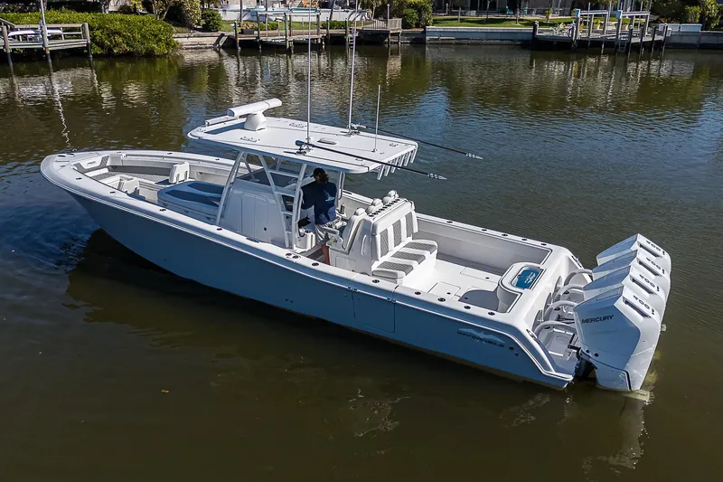  Yacht Photos Pics 2024 Invincible 39 Open Fisherman boat on calm water, featuring multiple outboard engines.