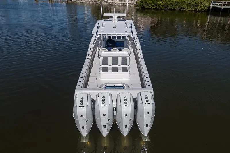  Yacht Photos Pics 2024 Invincible 39 Open Fisherman boat with quad engines on calm water.