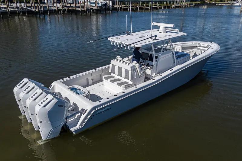  Yacht Photos Pics 2024 Invincible 39 Open Fisherman boat with triple engines on calm water.