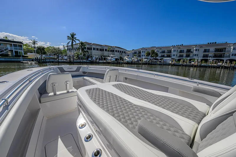  Yacht Photos Pics 2024 Invincible 39 Open Fisherman boat interior with luxurious seating and waterfront view.