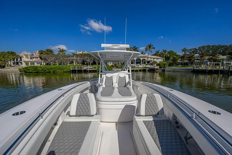  Yacht Photos Pics 2024 Invincible 39 Open Fisherman boat on calm water, featuring spacious seating and sleek design.