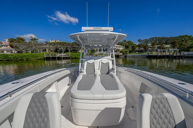  Yacht Photos Pics 2024 Invincible 39 Open Fisherman boat with luxurious seating on a sunny day.