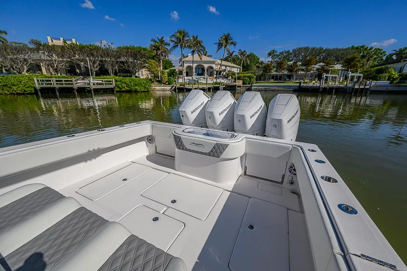  Yacht Photos Pics 2024 Invincible 39 Open Fisherman boat with quad engines, docked in a scenic marina.