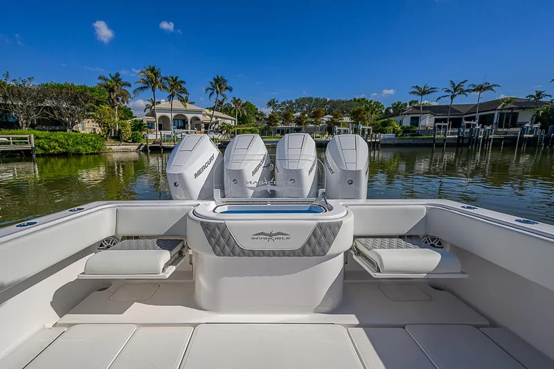  Yacht Photos Pics 2024 Invincible 39 Open Fisherman boat with four engines, docked by a scenic waterfront.